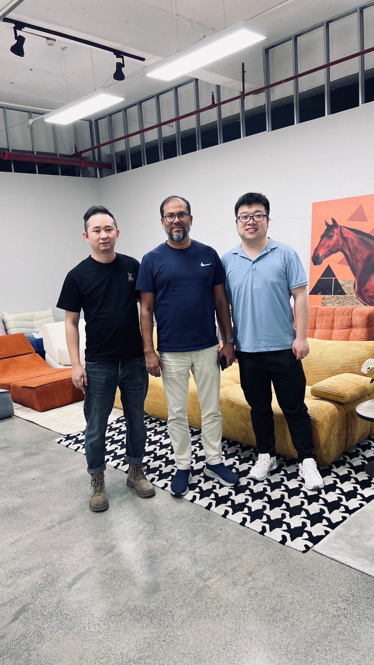Three people meeting in a sofa showroom